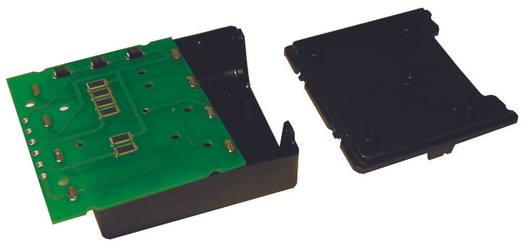 Green circuit board with black plastic casing, separated into two parts. The board has silver components and connectors.